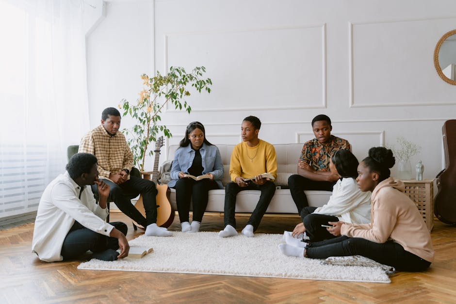 diverse group of believers smiling and praying together in a living room Apostolic fellowship