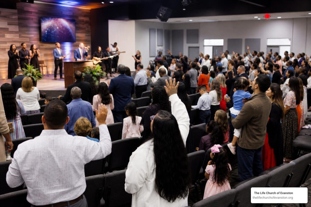 diverse multicultural congregation worshipping together in modern Apostolic Pentecostal church