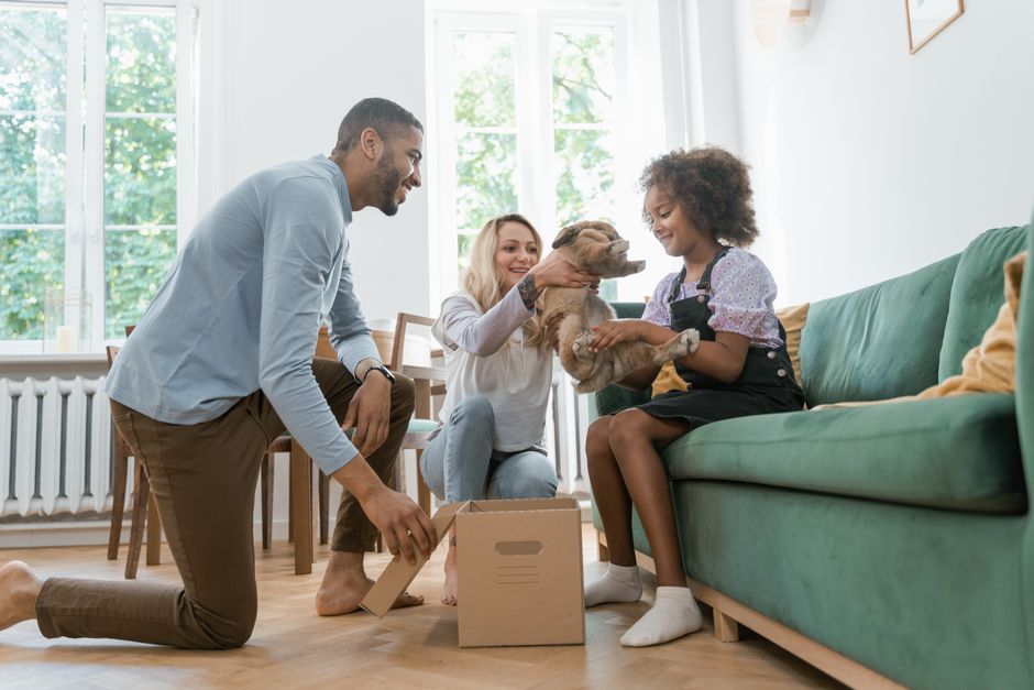 happy family welcoming an adopted dog at home